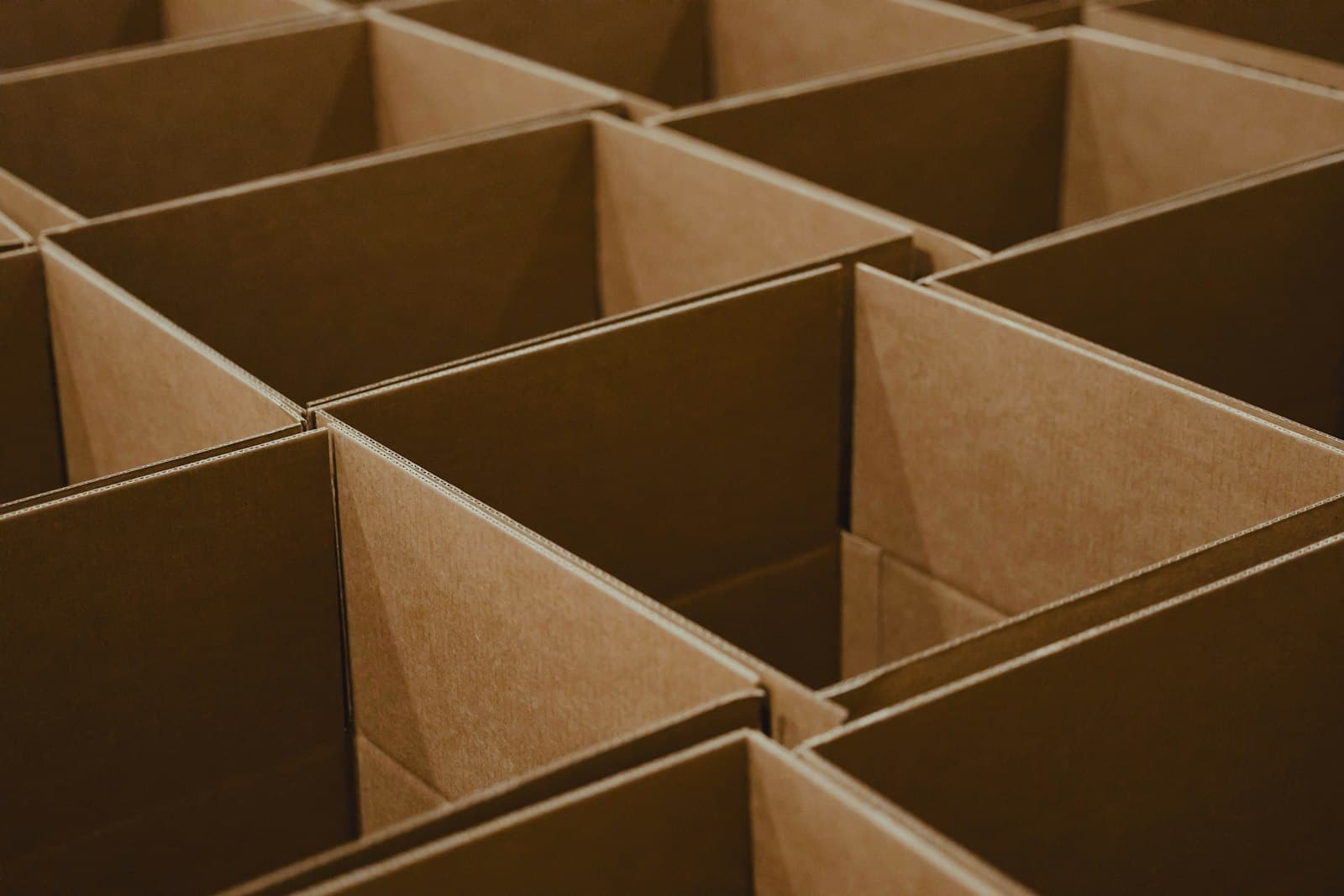 Stacks of opened brown corrugated shipping boxes in a UAE e-commerce fulfillment warehouse