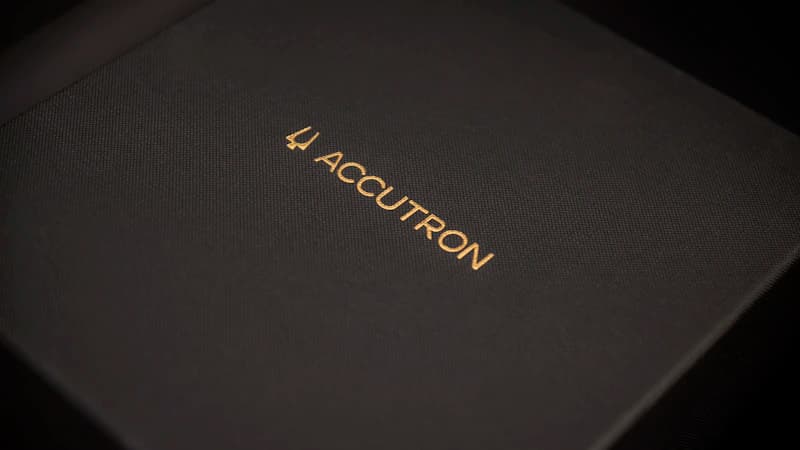 Close-up of a gold-foiled rigid perfume box with Arabic script accents